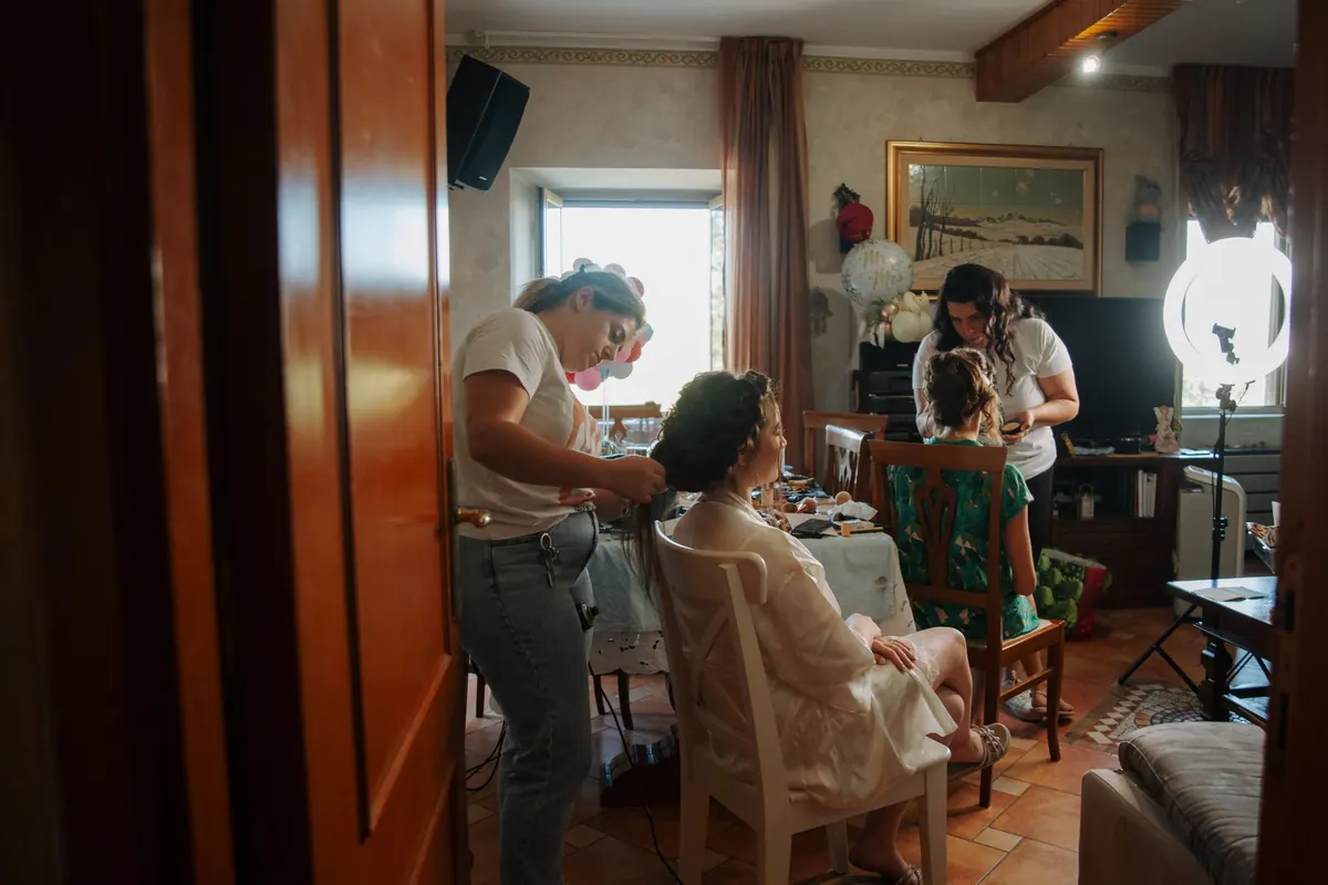 A bride getting ready with family around her, one of hundreds of frames in a wedding gallery