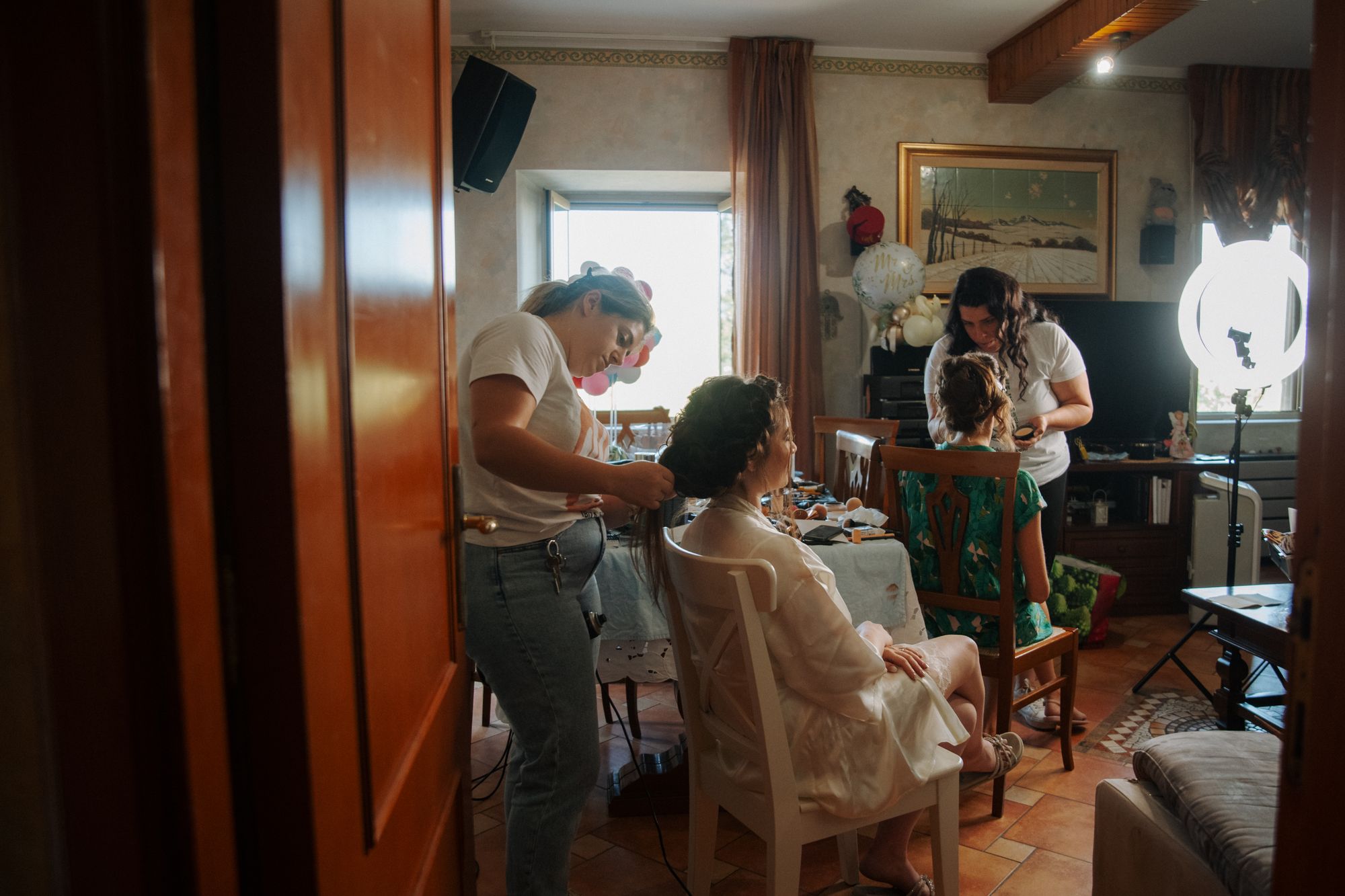 A bride getting ready with family around her, one of hundreds of frames from a full wedding day